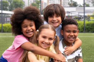 kids-smile-at-camera-outdoors